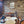 Dining area with wooden wall paneling, chairs, and lanterns.