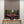 Modern interior with a television displaying nature scene, below a wooden slat panel.