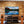 TV mounted on a wooden wall with speakers and entertainment console below.