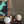 Decorative setup with books, a vase, and a spherical object against a wooden wall.
