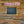 Wooden wall with a blackboard and 'Give a Fit' neon sign.