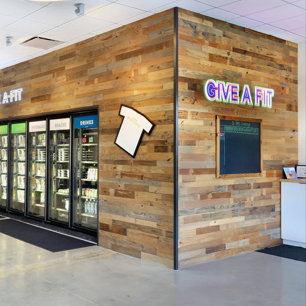 Wooden wall with a store entrance and 'Give a Fit' sign.