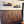 Wooden wall paneling with shelves above featuring decorative items.