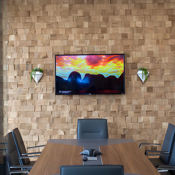 Conference room with wooden wall, TV displaying a mountain scene, and wooden table.