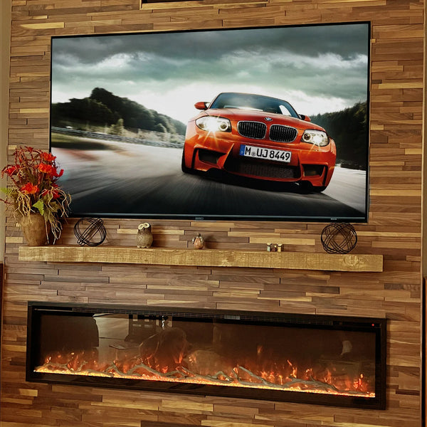 TV mounted on a wooden wall displaying a car, below which is an electric fireplace.
