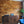 Wooden wall paneling with a wooden cabinet and blue sofa in a room.