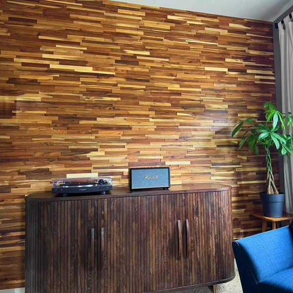 Wooden wall paneling with a wooden cabinet and blue sofa in a room.