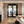 Living room with a view of an office through a glass door.