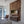 Modern bedroom with wooden wall paneling, TV, and view of water.
