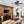 Modern living room with wooden wall, TV, and furniture