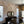 Dining room with geometric wall design, mirror, and table.