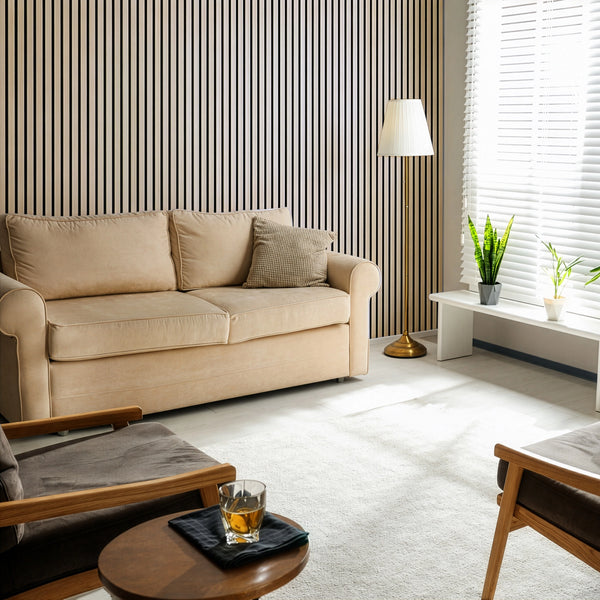 Modern living room with beige sofa, wooden armchair, and striped wallpaper.