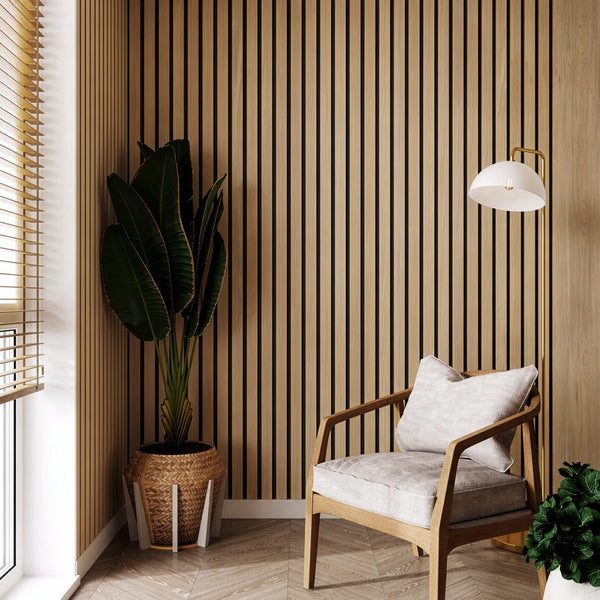 Modern interior with a wooden armchair, striped wall, and potted plants.