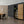 Modern interior with a wooden cabinet, bookshelf, and dining table.