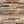 Reclaimed wood panel wall with various shades of brown and gray.
