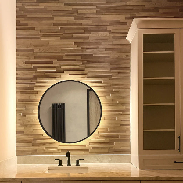 Bathroom with wooden wall paneling, round mirror, and wooden cabinet.