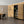 Modern interior with wooden wall paneling, bookshelf, and dining table.